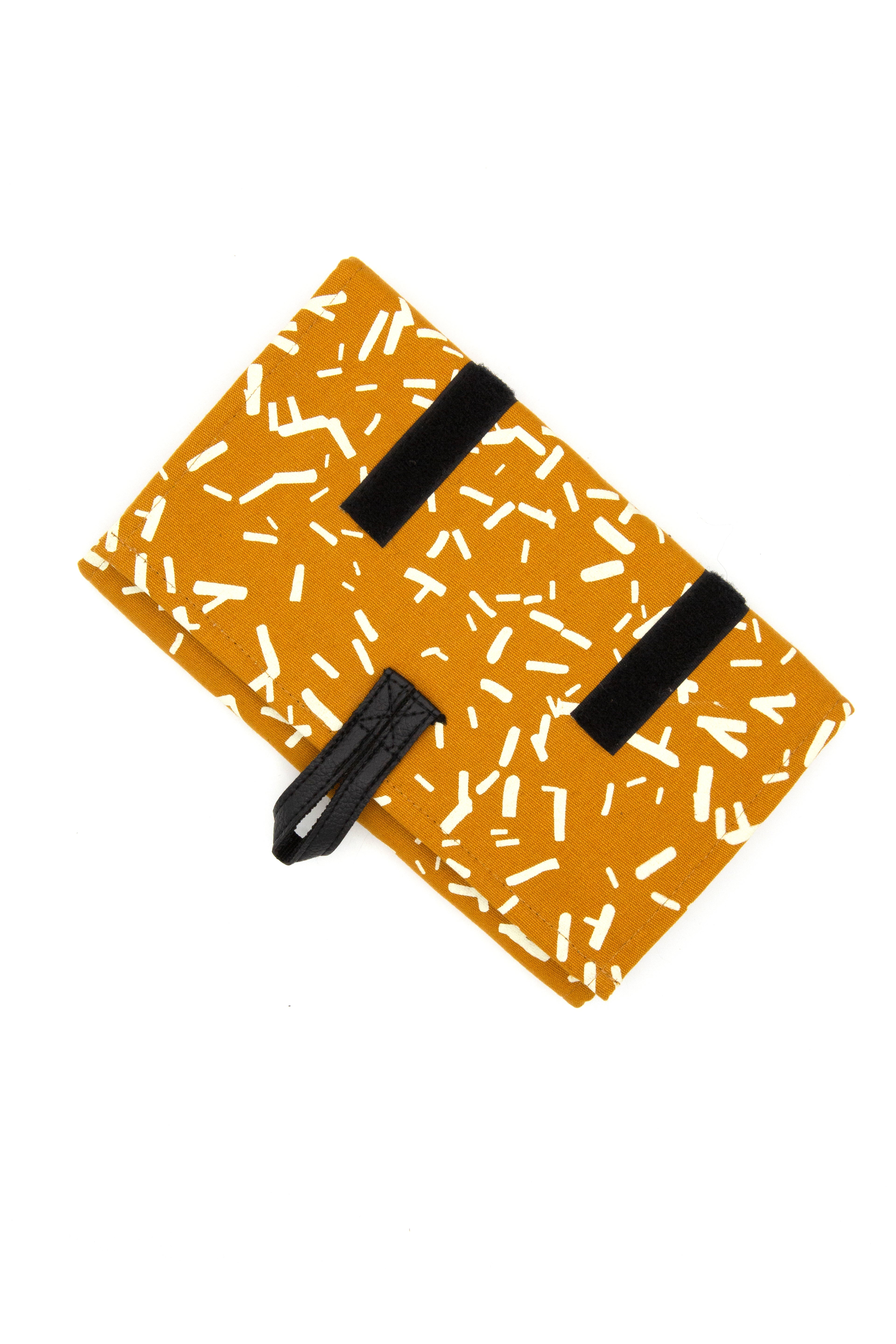 Wayfarer Jewelry Roll Travel Case in Confetti Mustard, rolled up and tied, handmade from organic cotton by Fair Anita