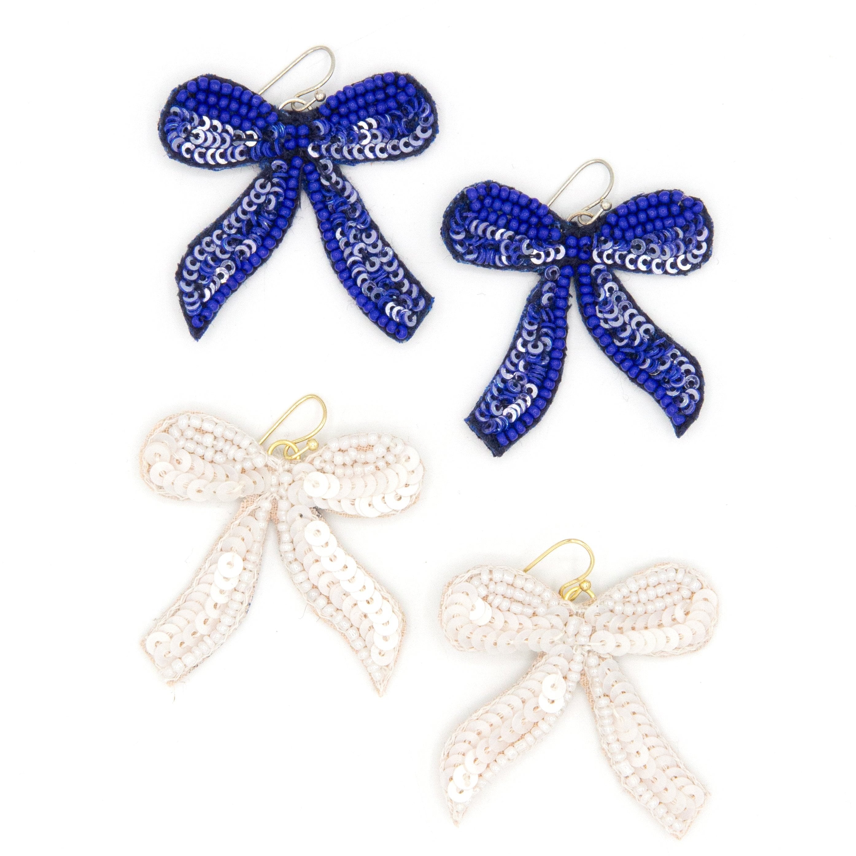 Fair Anita beaded bow earrings handmade with glass beads and sequins on a light background