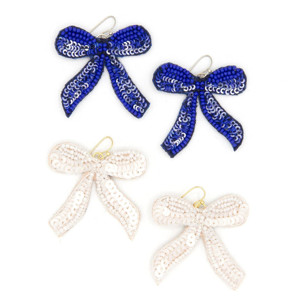 Fair Anita beaded bow earrings handmade with glass beads and sequins on a light background