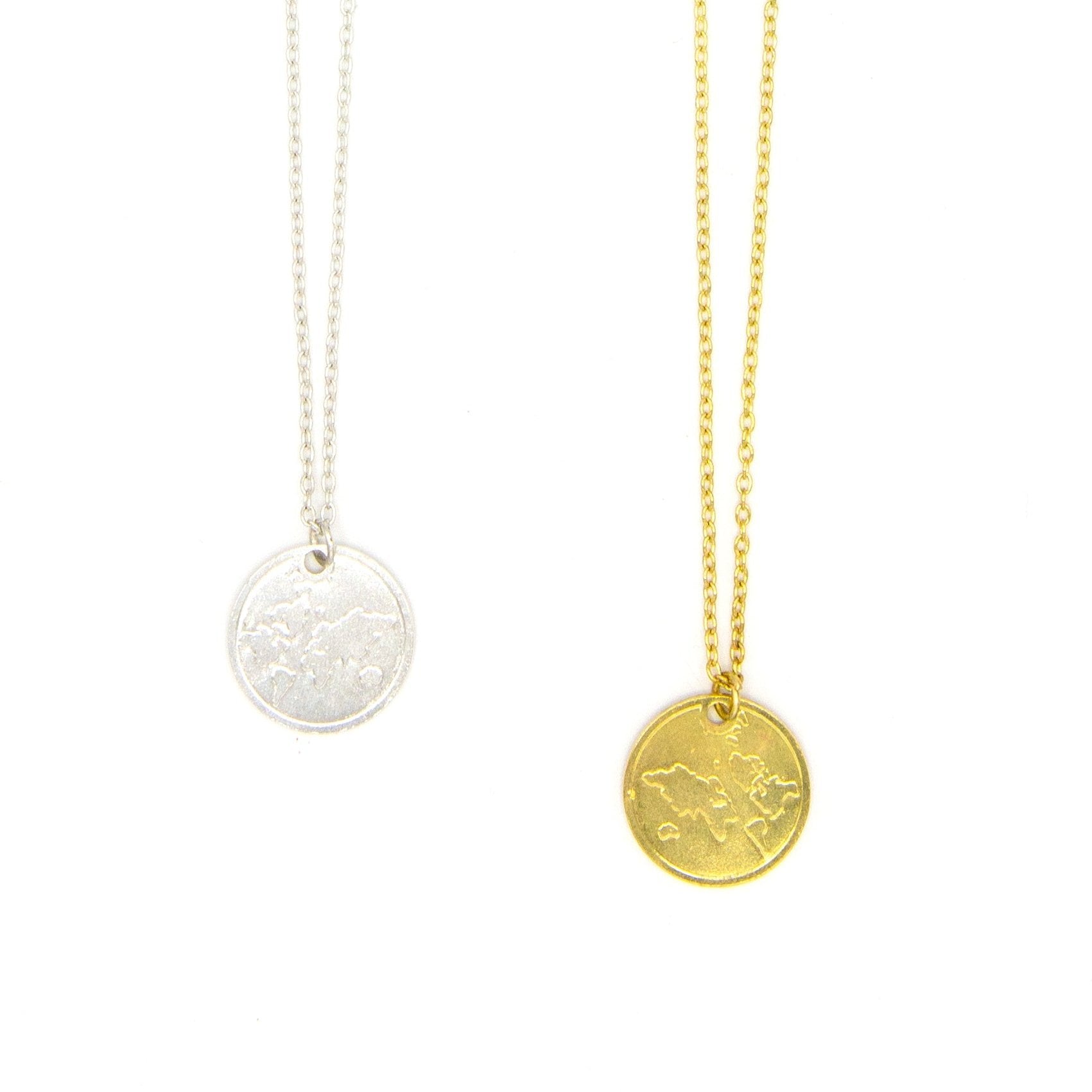 Gold-plated globe pendant necklace on model, showing double-sided world map design by Fair Anita