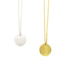Gold-plated globe pendant necklace on model, showing double-sided world map design by Fair Anita