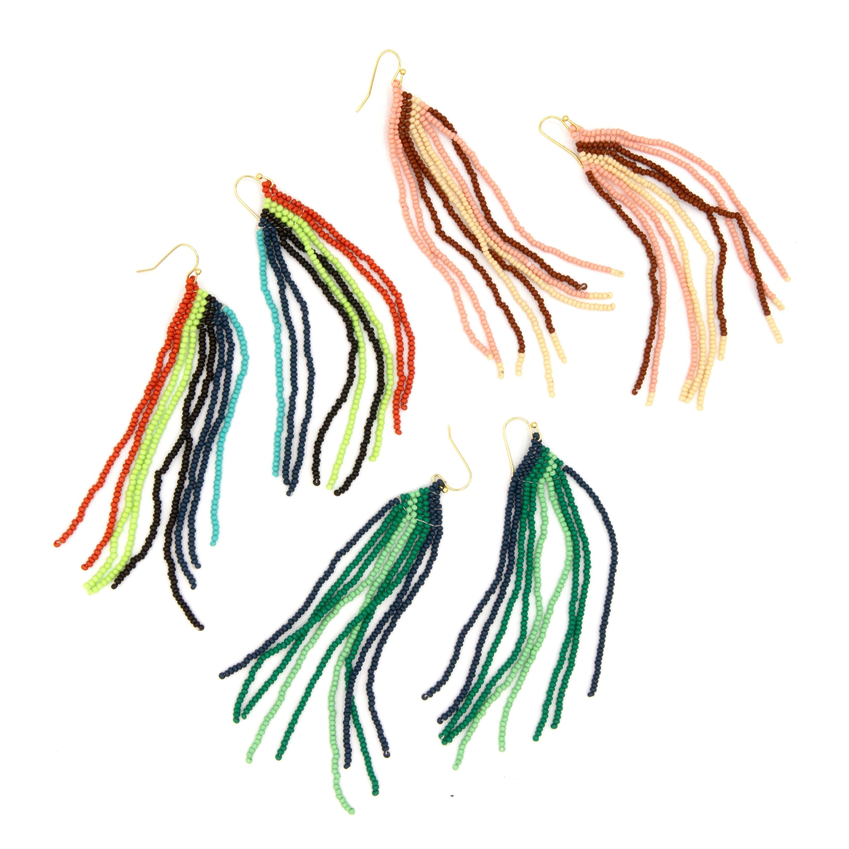 Colourful beaded fringe earrings handcrafted by Fair Anita artisans, shown on a flat lay surface
