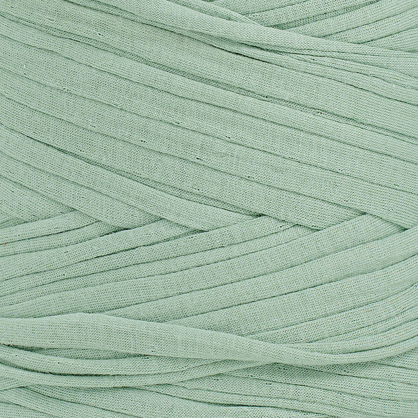 Close-up of Agave recycled fabric yarn showing flat ribbon texture and earthy green tone