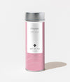 Pink tea canister with silver lid labeled 'Cleanse' by 'Art of Tea' on a white background