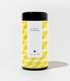 A cylindrical canister of Art of Tea Egyptian Chamomile tea, featuring a black lid and base with a yellow and white geometric cube pattern on the label, set against a plain white background.