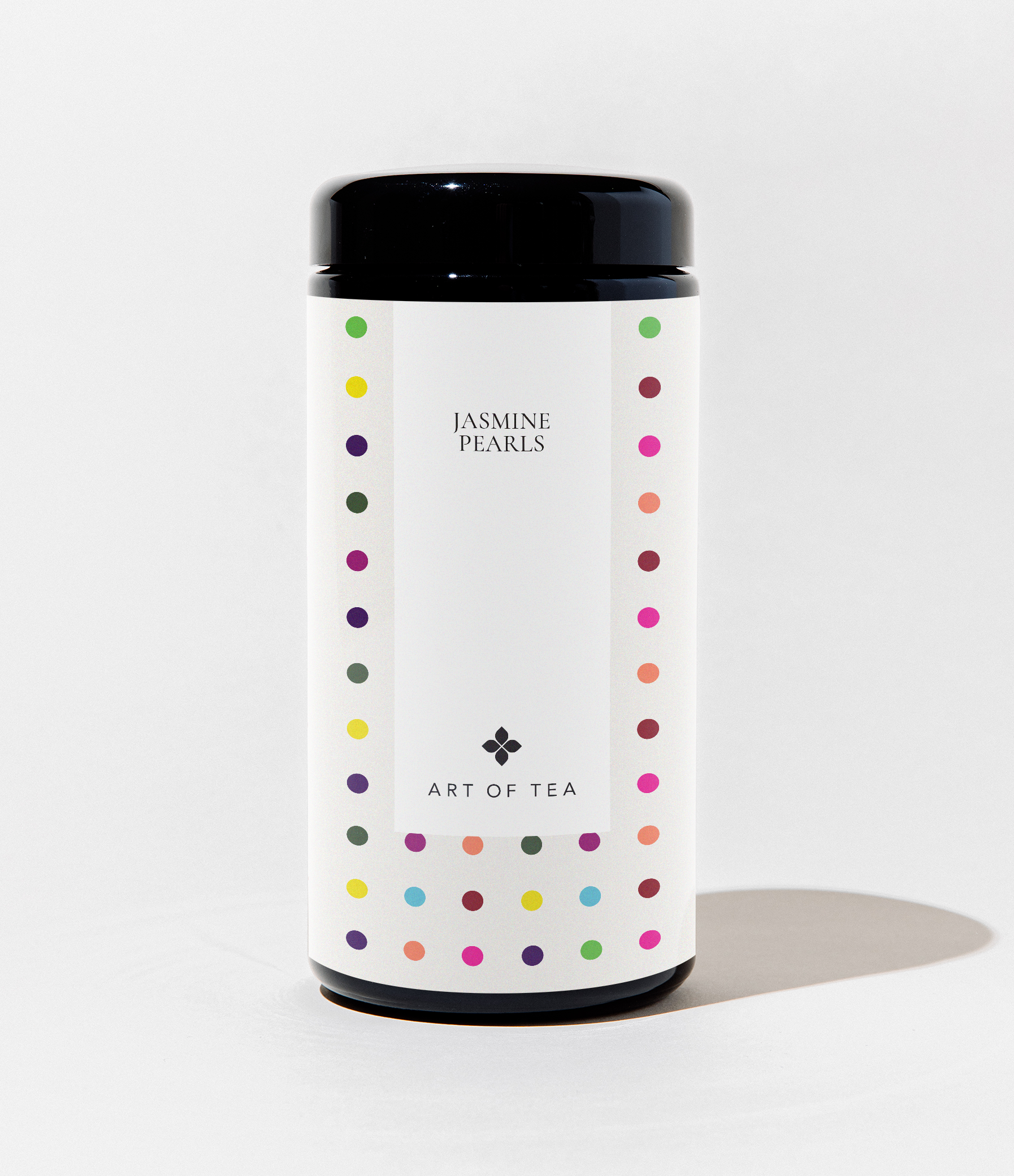 Tea canister with colorful polka dot design on a white background