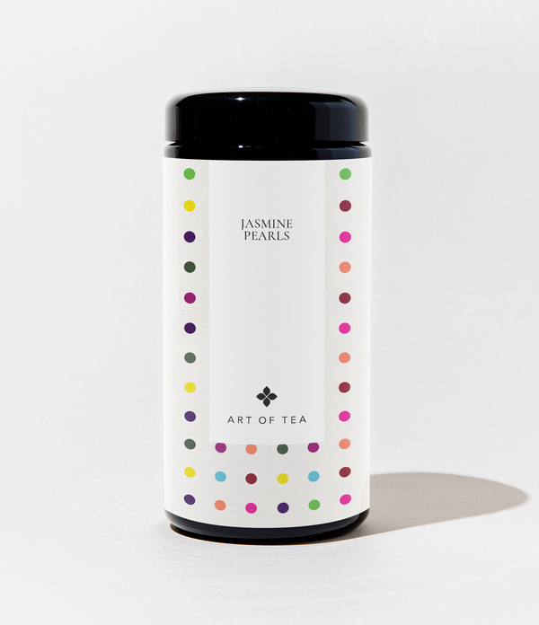 Tea canister with colorful polka dot design on a white background
