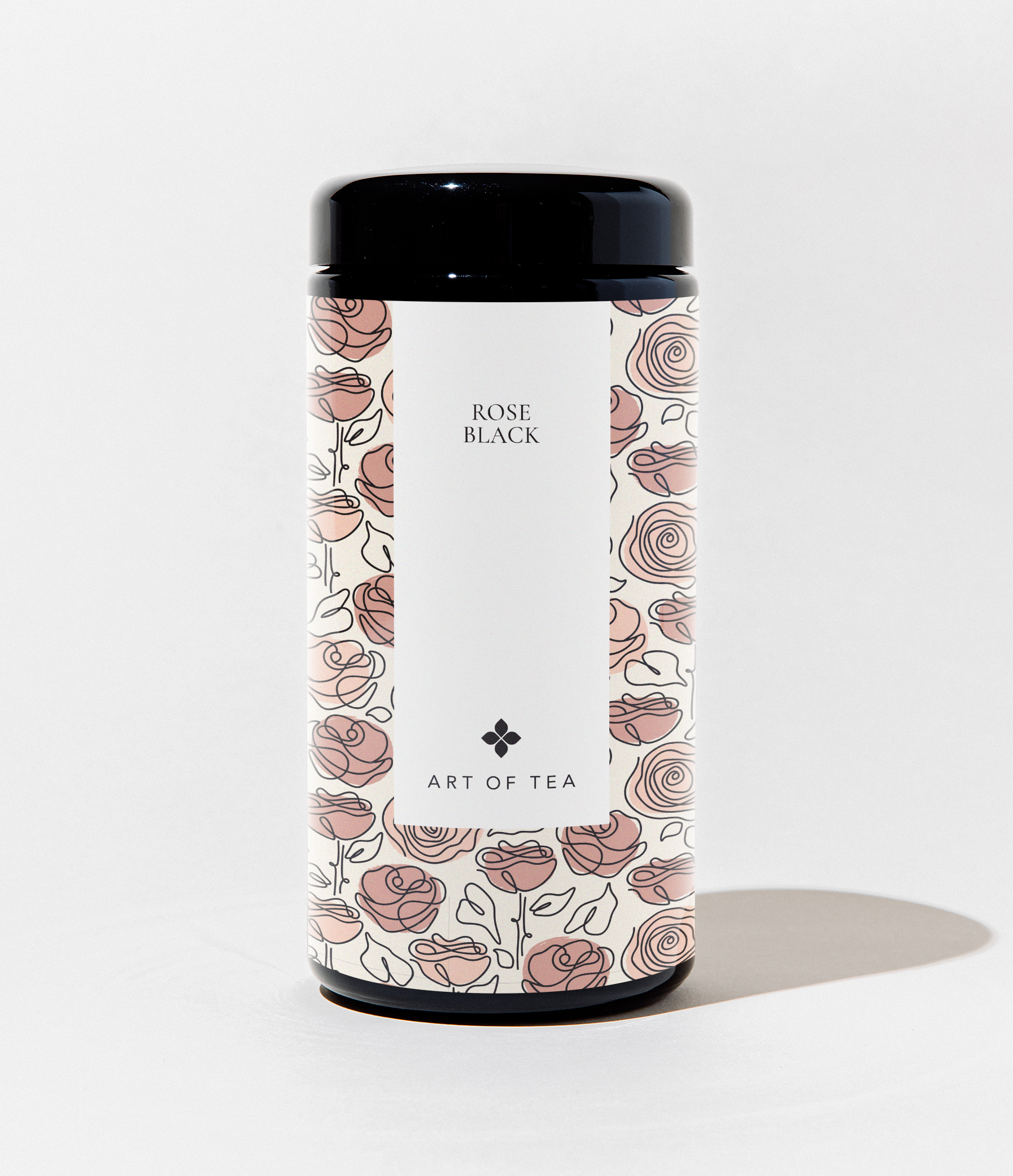 A cylindrical canister of Art of Tea Rose Black tea, featuring a black lid and base with a white central label decorated with a dusty rose and black rose pattern.