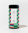 A cylindrical canister of Talis Masala Chai Art of Tea, featuring a colorful geometric pattern border and a clean white center label with black text, set against a plain white background.