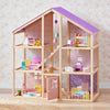 Wooden dollhouse with colorful furniture and toys on a floral wallpaper background