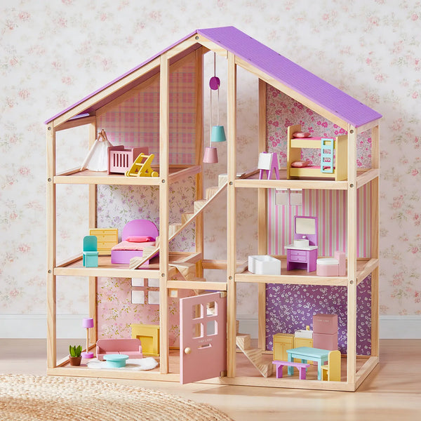 Wooden dollhouse with colorful furniture and toys on a floral wallpaper background