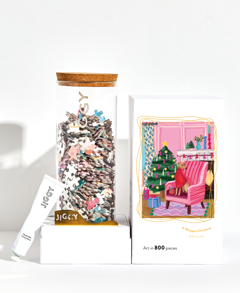 Jigsaw puzzle box with a Christmas scene illustration on a white background