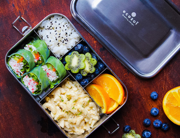 Ecozoi stainless steel lunch box open showing five food compartments and included 50ml sauce container