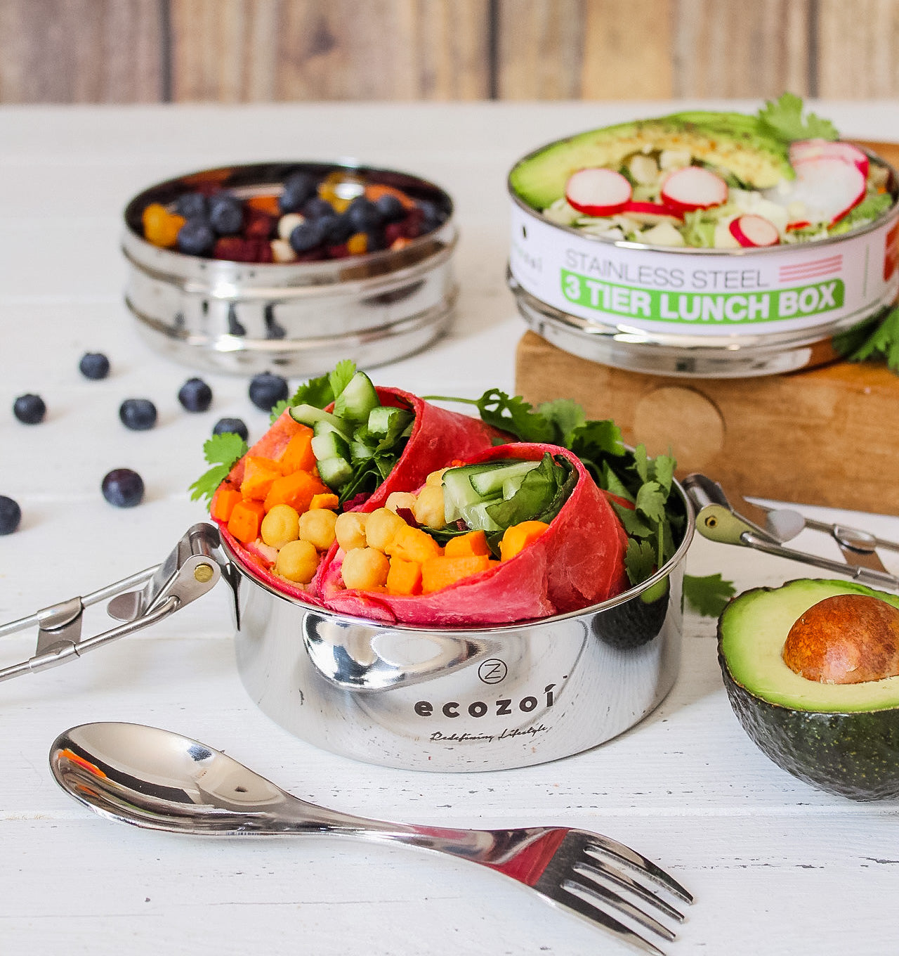 Ecozoi 3-tier round stainless steel lunch box open showing three stackable compartments filled with food