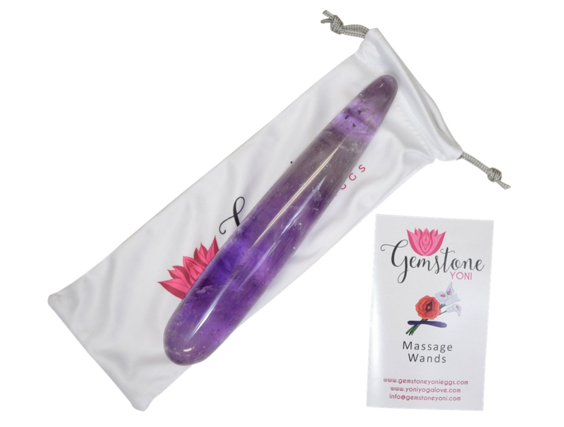 Amethyst yoni wand laid flat displaying smooth straight shape and gemstone finish