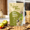 Doyy Oats Apple Ginger Overnight Oats package on a wooden surface with apples and ginger.