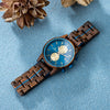 Aries zebrawood chronograph watch laid flat showing unique wood grain detail and watch face
