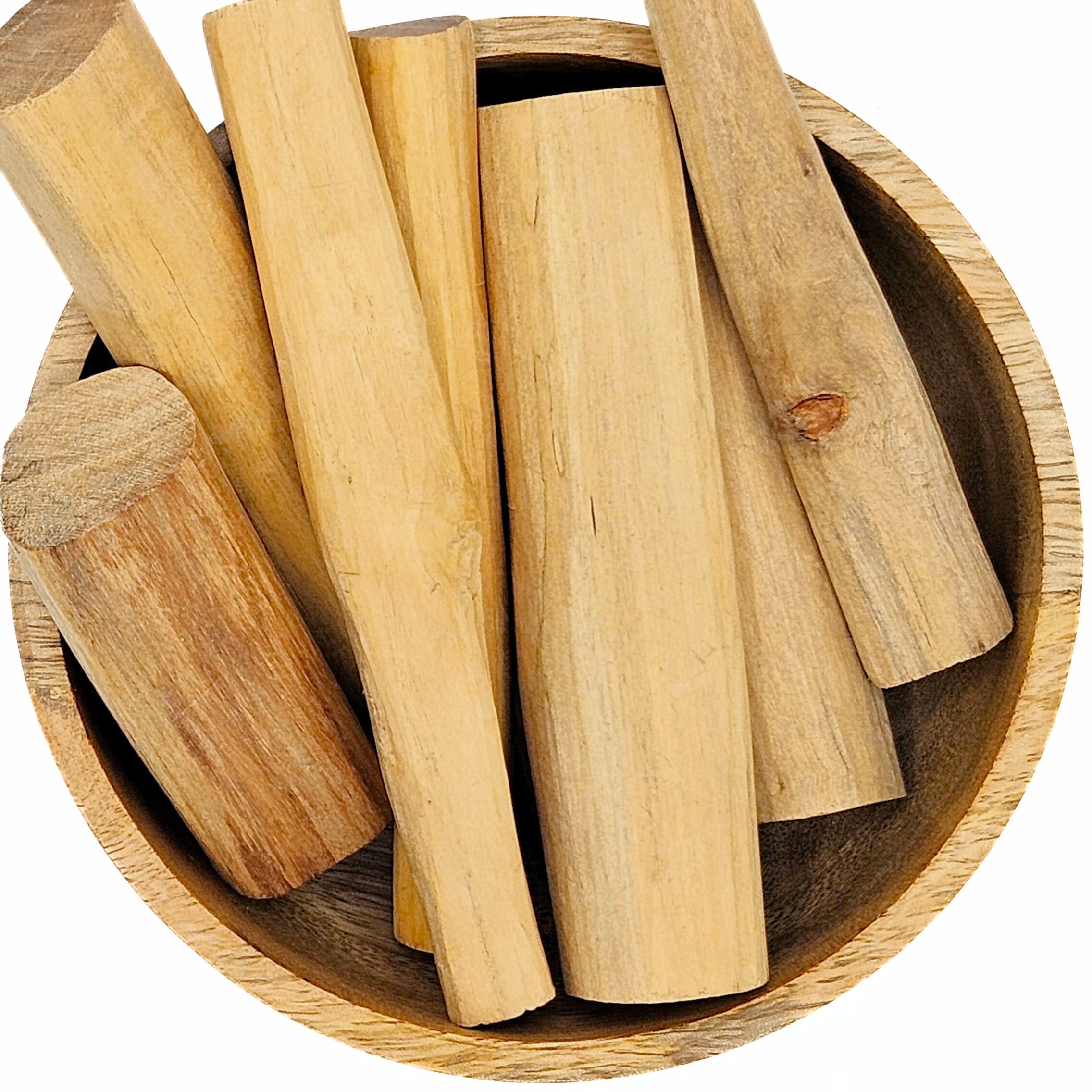 Wooden incense sticks in a wooden bowl on a white background