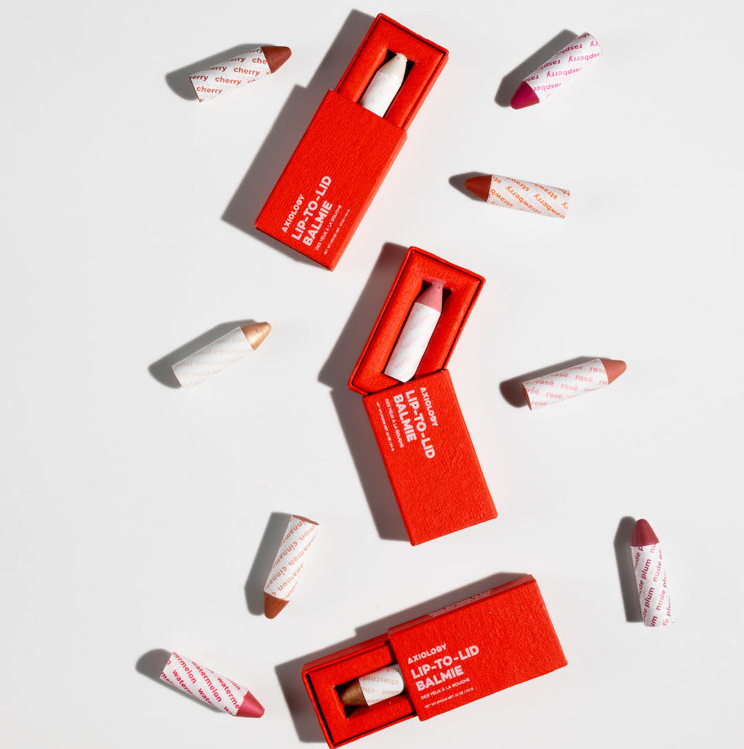 Red lip balm packaging with visible lip balm on a white background