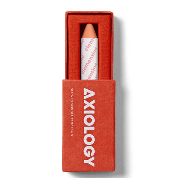 Axiology makeup pencil in a red box on a white background. Axiology's award-winning Balmie crayon — vegan, plastic-free & handmade in the USA. Multi-use color for lips, eyes & cheeks. On Oprah's Favorite Things List. Shop now.