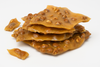 Stack of peanut brittle on a white background