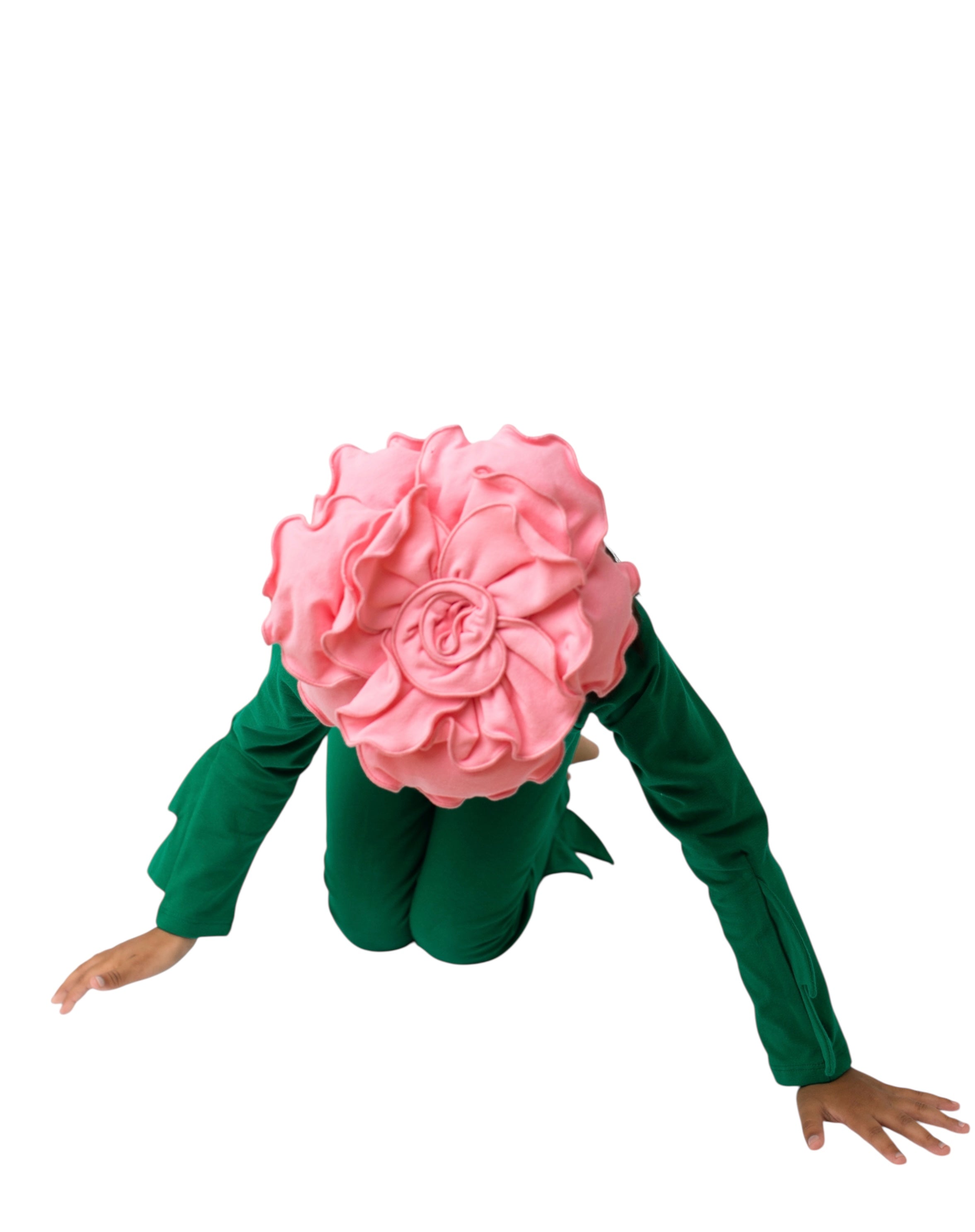 Person wearing a green outfit with a large pink flower headpiece on a white background