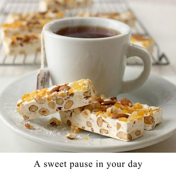 Andy Anand gluten-free orange peel turron nougat sliced to show candied orange peel pieces in soft honey nougat
