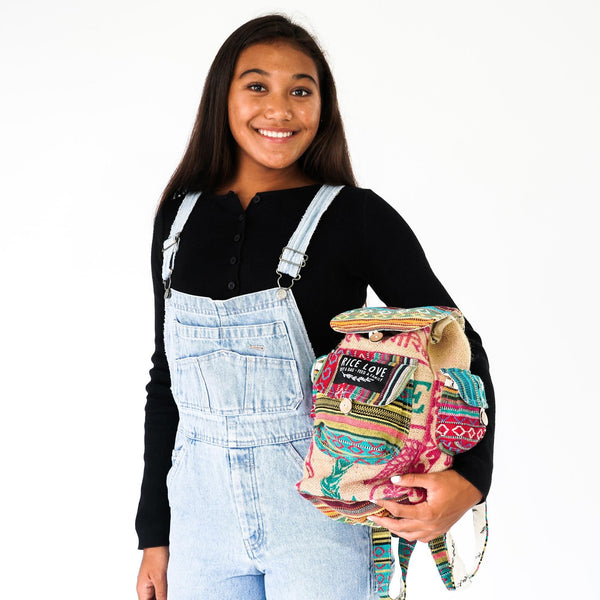 Person holding a colorful backpack with a white background