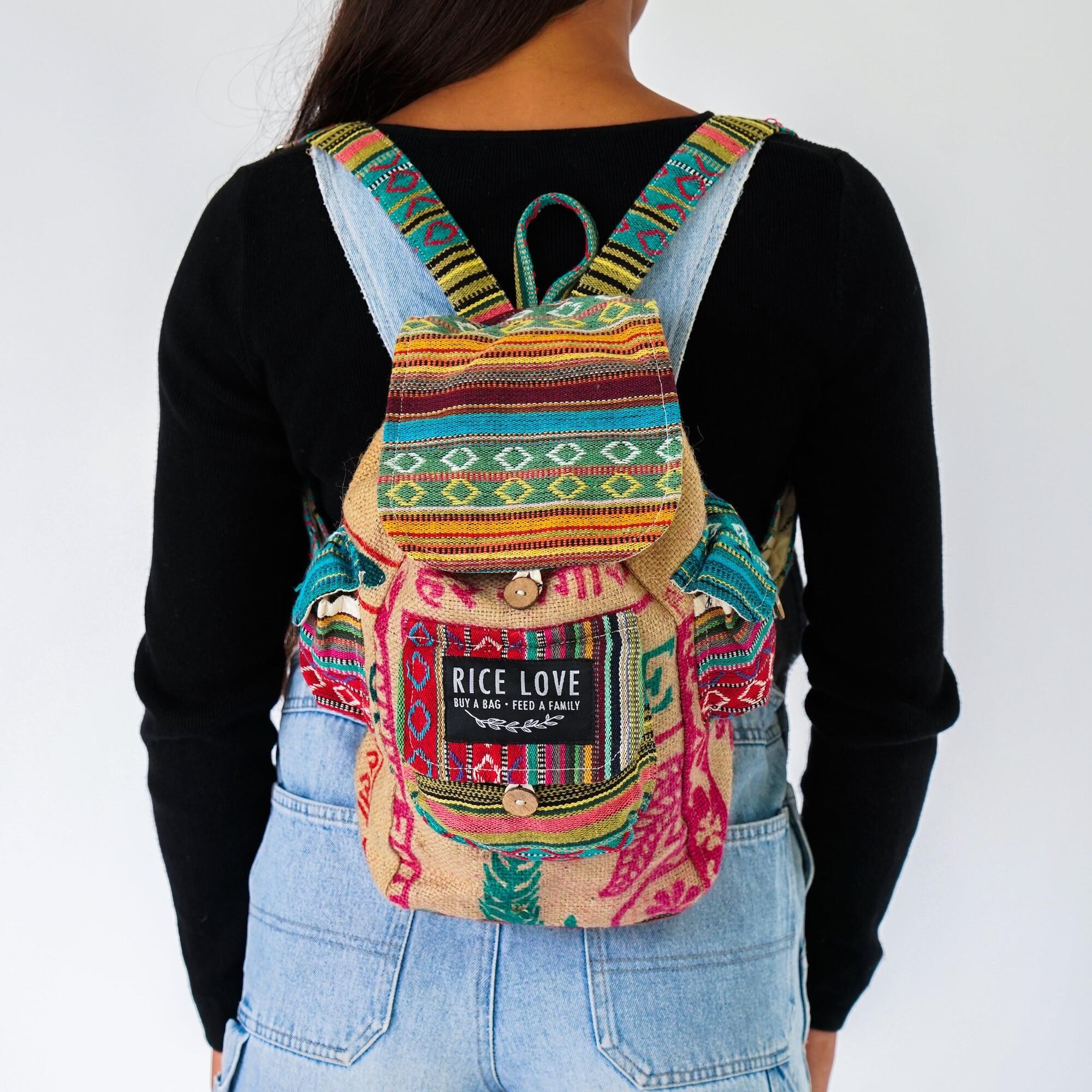 Colorful backpack with 'Rice Love' label worn by a person on a white background