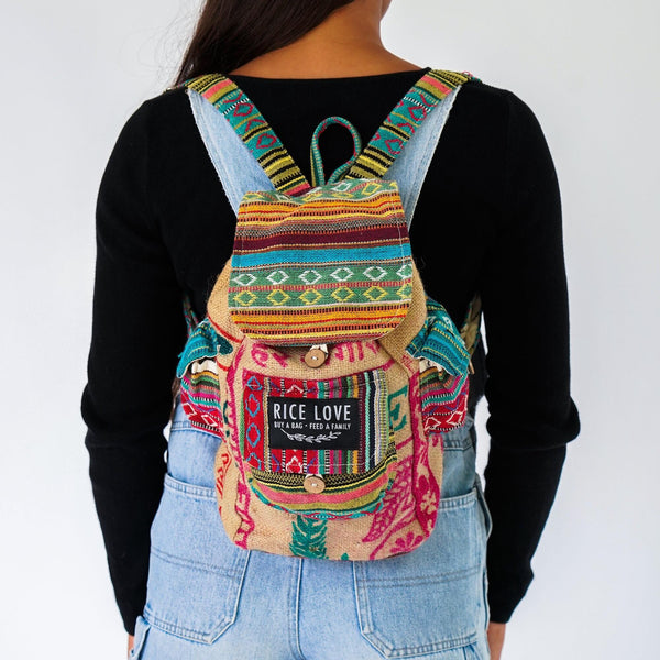Colorful backpack with 'Rice Love' label worn by a person on a white background