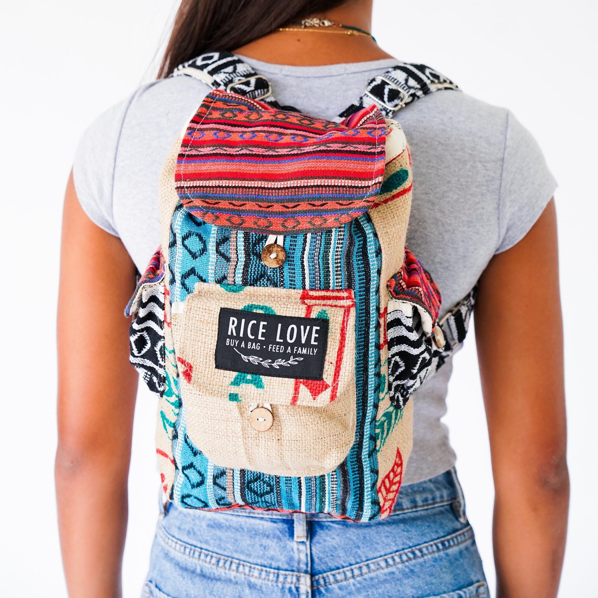Person wearing a colorful backpack with 'Rice Love' label on a white background