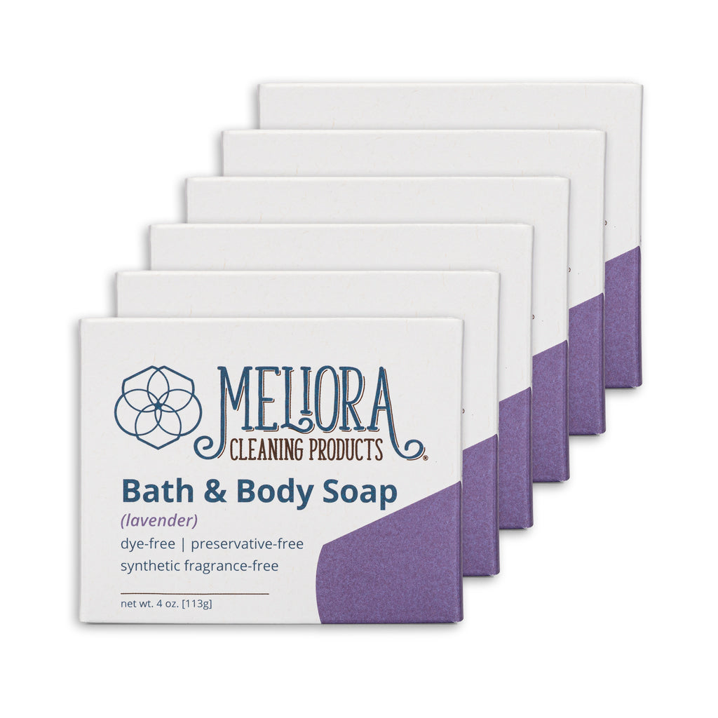 Five bars of Mejora Cleaning Products Bath & Body Soap arranged in a staggered row on a white background. The soap bars are white with a purple corner design and purple side panels.