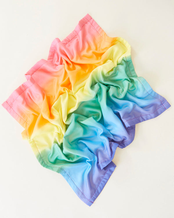 Close-up detail of Sarah's Silks rainbow silk baby blanket texture and colour gradient