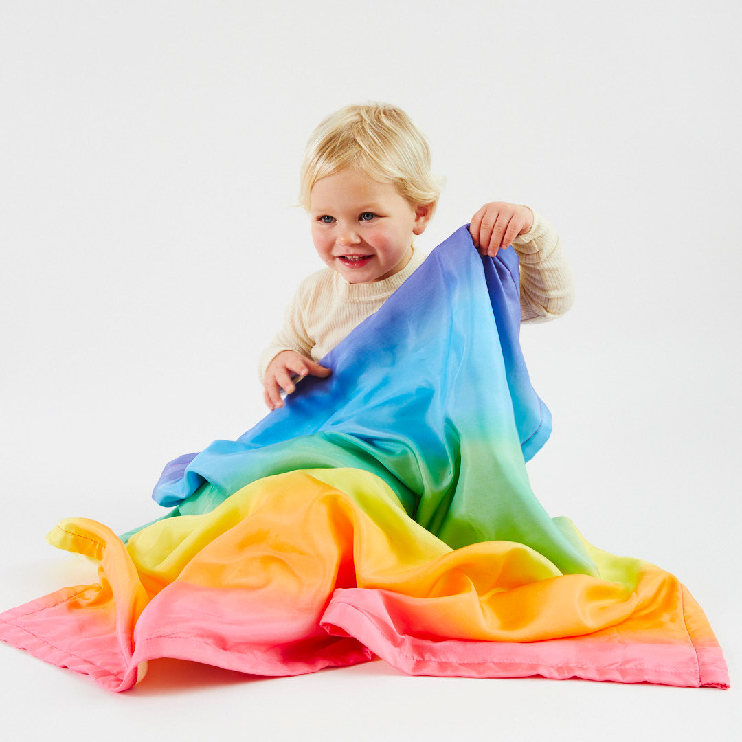Sarah's Silks eco-friendly rainbow baby blankets folded and stacked showing full product range