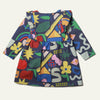 Close-up detail of the Mon Coeur baby ruffle dress showing the multicolour non-toxic print and snap button back fastening