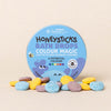 Honeysticks Color Magic bath drops displayed in open recyclable tin showing 27 colorful drops