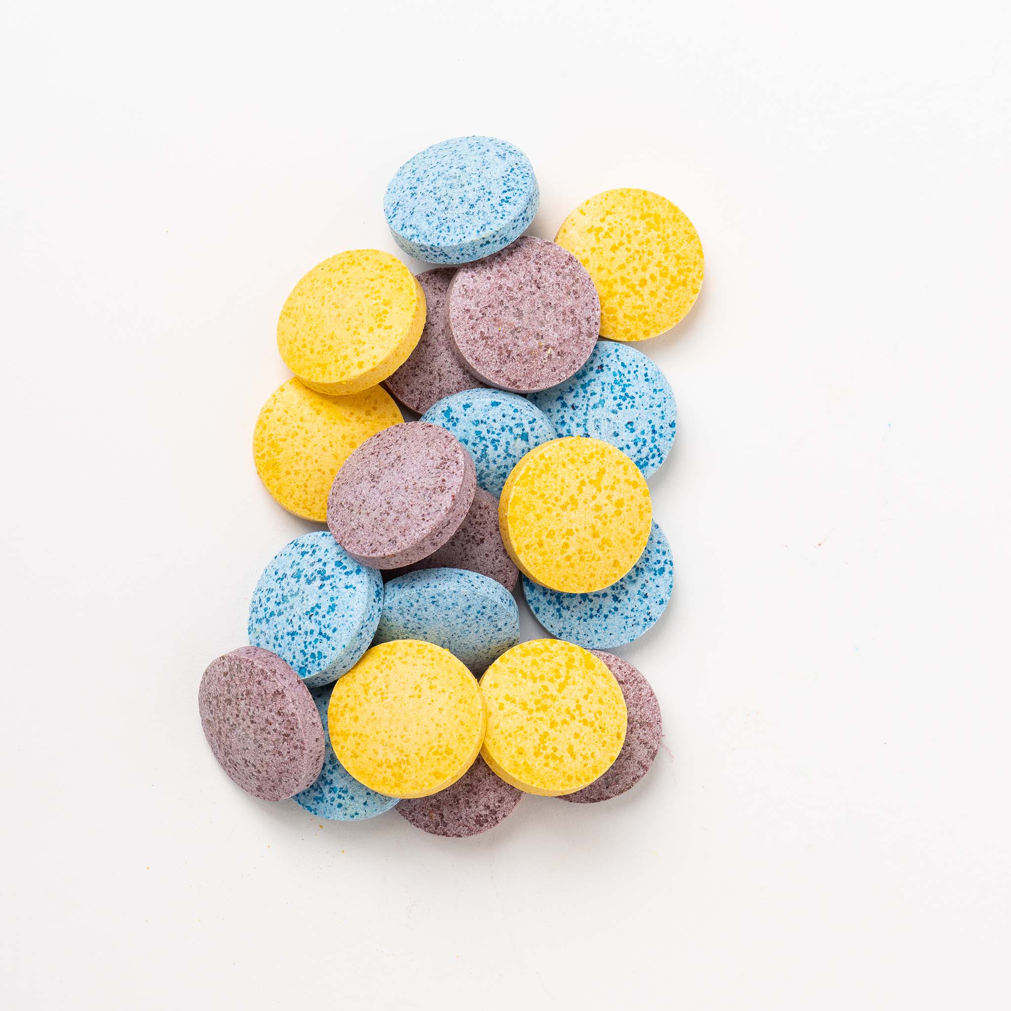 Child mixing Honeysticks Color Magic bath drops in water to create colorful bath time sensory play