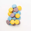 Child mixing Honeysticks Color Magic bath drops in water to create colorful bath time sensory play