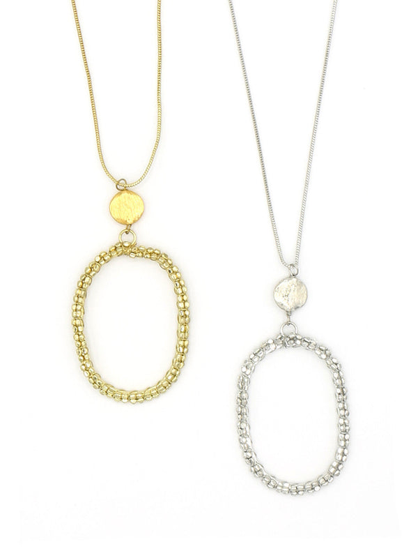 Fair Anita beaded hollow oval pendant necklace in gold and silver-plated recycled metal on a long chain