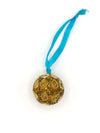 Close-up of small traditional beaded ornament handcrafted by women artisans in India, measuring 1.5 inches across