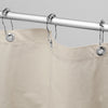 Beige shower curtain with silver rings on a gray background