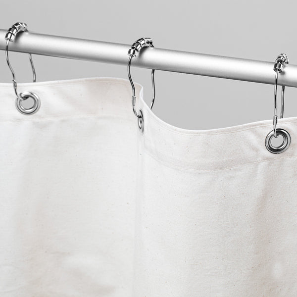 White shower curtain with silver rings on a gray background