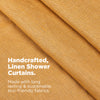 Close-up of beige fabric with text about handcrafted, linen shower curtains made from eco-friendly materials.