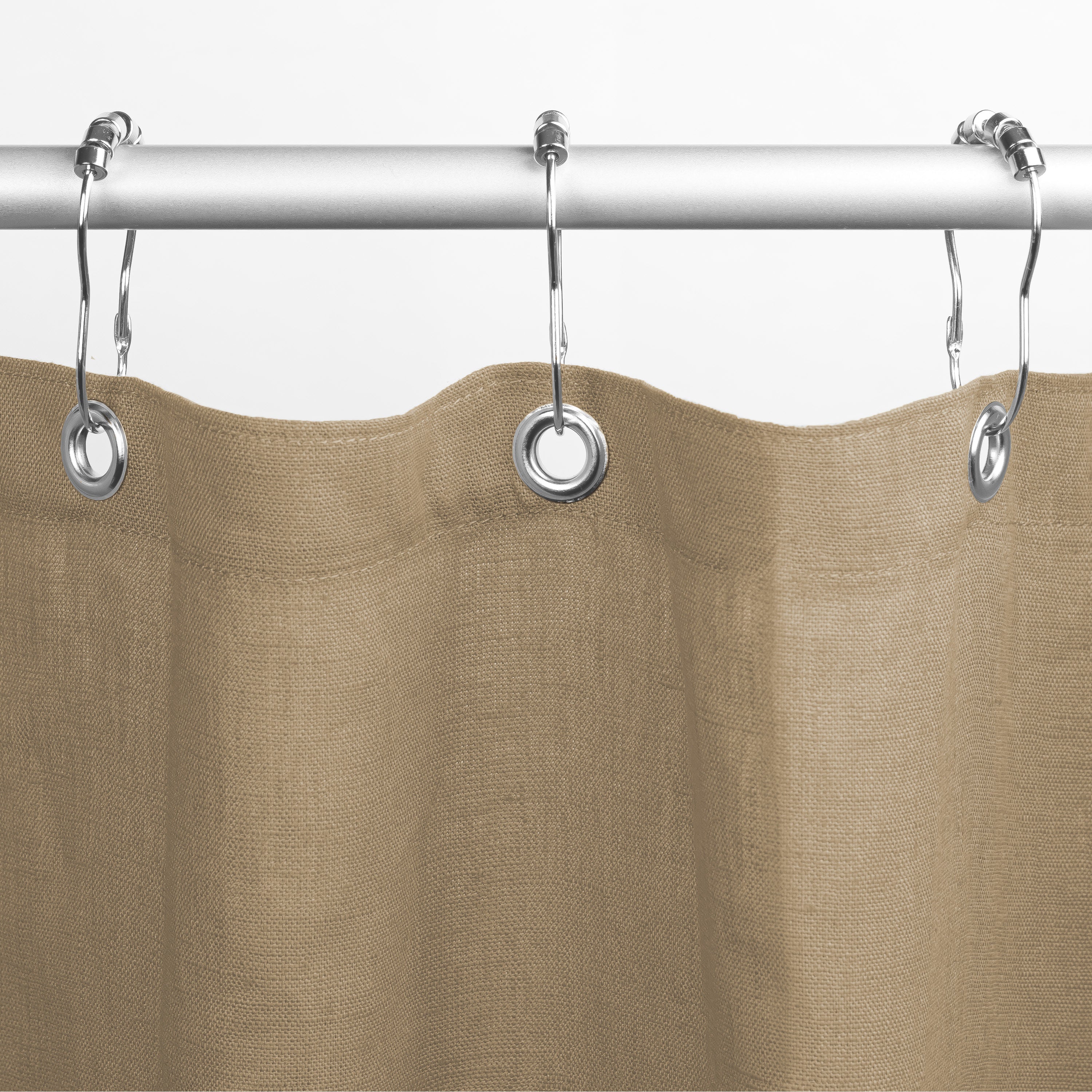 Brown shower curtain with silver rings on a white background