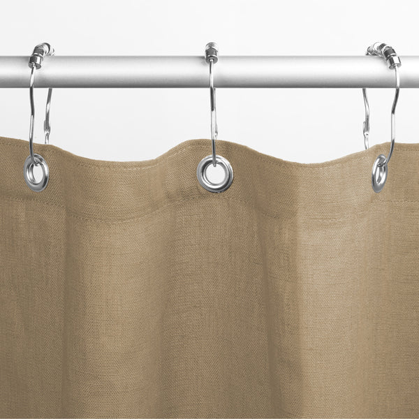 Brown shower curtain with silver rings on a white background