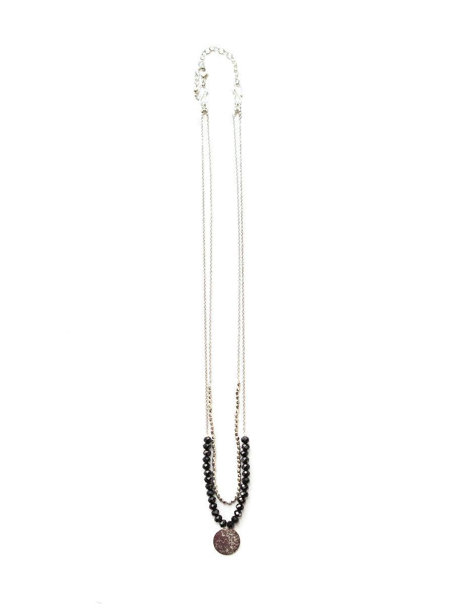 Long beaded necklace with a pendant on a white background