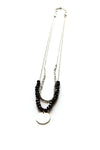 Black beaded pendant necklace by Fair Anita showing hammered silver pendant detail on single strand