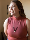 Black beaded convertible necklace worn as a single strand with hammered silver pendant by Fair Anita