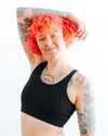 Woman wearing Thunderpants Black Longline Bra, side view