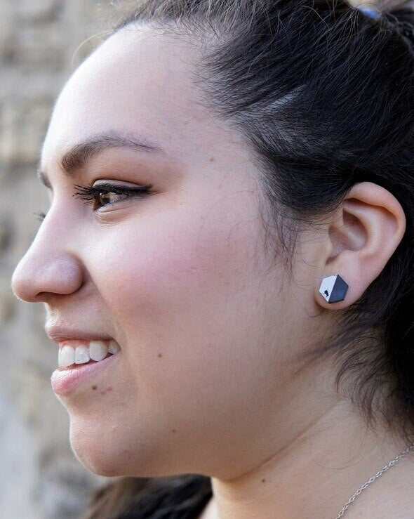 Close-up of black and white geometric hexagon stud earrings made from clay and resin – Fair Anita